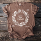 Brown t-shirt with circular design featuring insects and the text "LOVE THE UNLOVED".