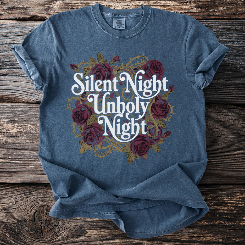 Blue t-shirt with white text "Silent Night Unholy Night" and dark red roses.