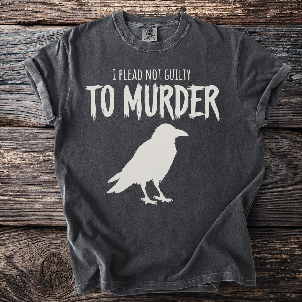 Charcoal t-shirt with white text "I plead not guilty to murder" and a raven graphic.