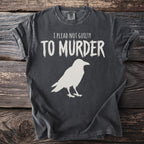 Charcoal t-shirt with white text "I plead not guilty to murder" and a raven graphic.