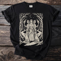 Black t-shirt with a graphic featuring a crowned triple goddess, keys, two dogs, and torches.