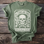 Green t-shirt with skull, bones, plants, and text "All Plants Are Edible Some Only Once".