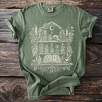 Green t-shirt with occult-themed graphic of shelves holding jars, a skull, and an open book.