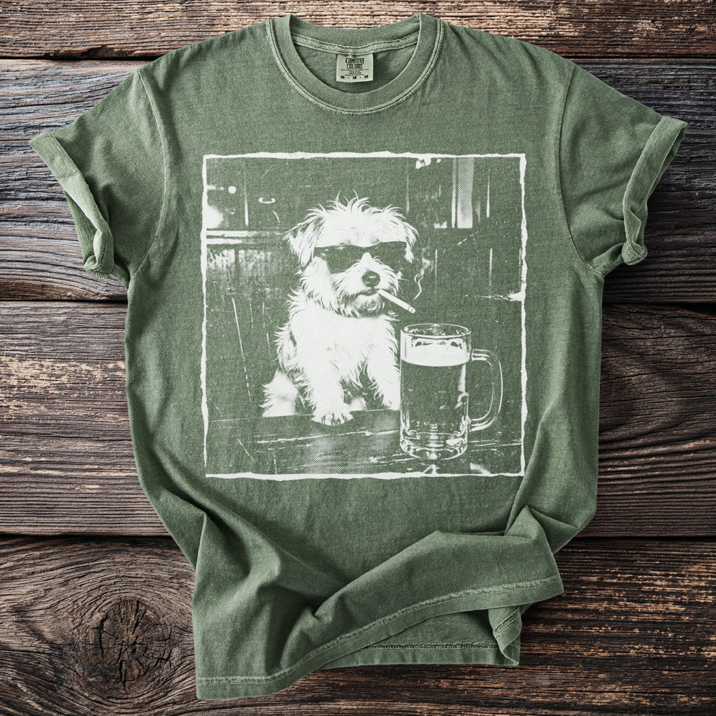 Green t-shirt with white graphic of a dog wearing sunglasses and smoking a cigarette.