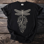 Black t-shirt with cream-colored dragonfly and floral design on chest.