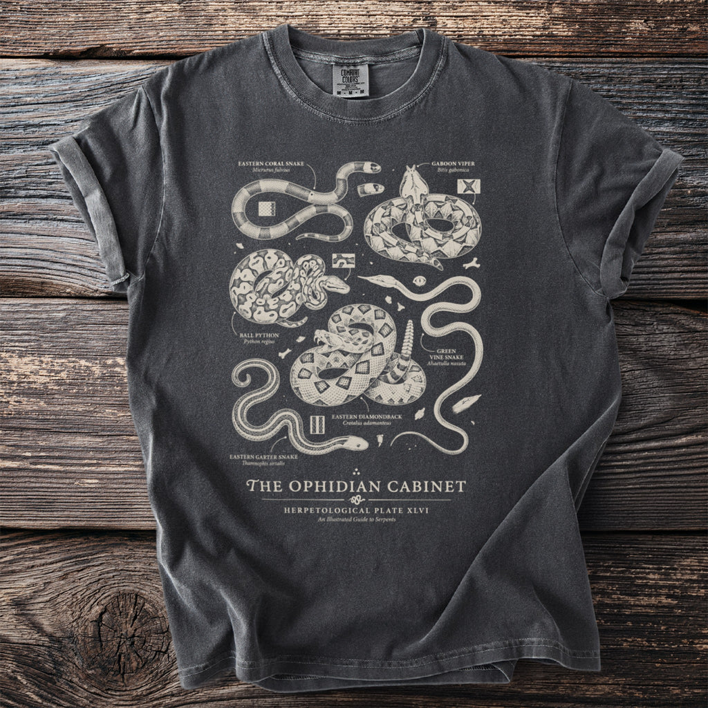 Dark grey t-shirt featuring an illustrated scientific plate of various snakes called "The Ophidian Cabinet".