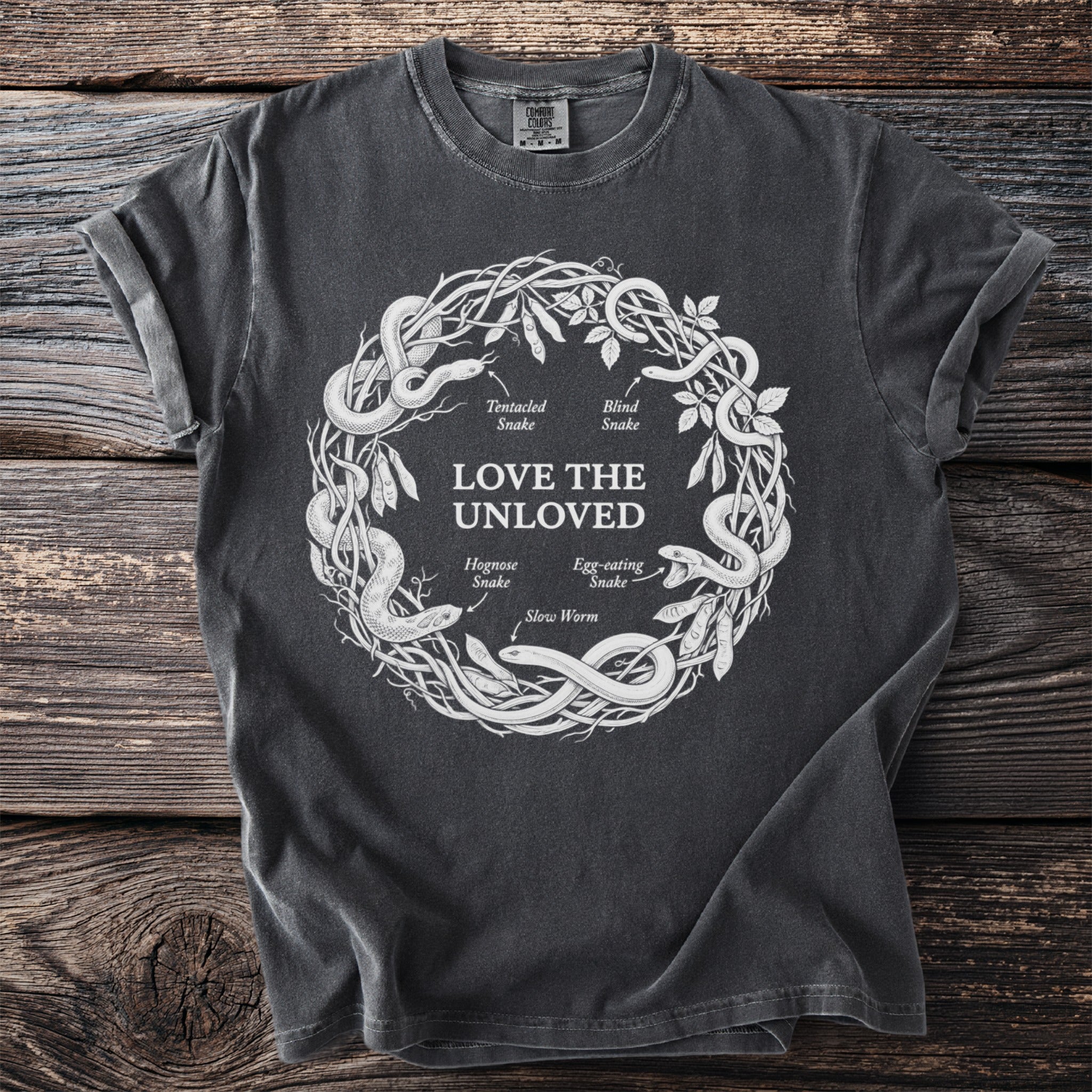 Dark gray t-shirt with "LOVE THE UNLOVED" and snake illustration.