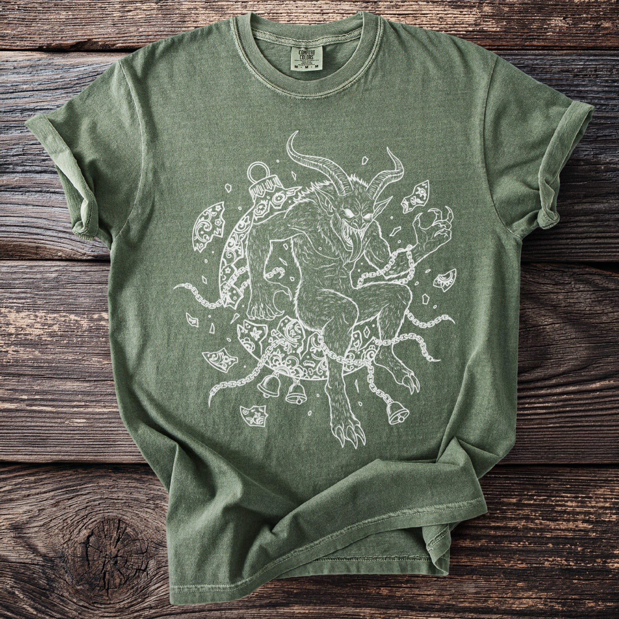 Green t-shirt with white line art of Krampus wrapped in chains and bells.