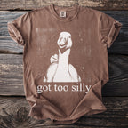 Brown t-shirt with white goose graphic and "got too silly" text.