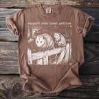 Brown t-shirt with "support your local goblins" and an illustration of two opossums.