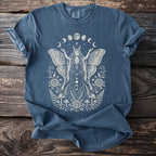 Blue t-shirt with cream moth woman, moon phases, roses, mushrooms, and ferns graphic.