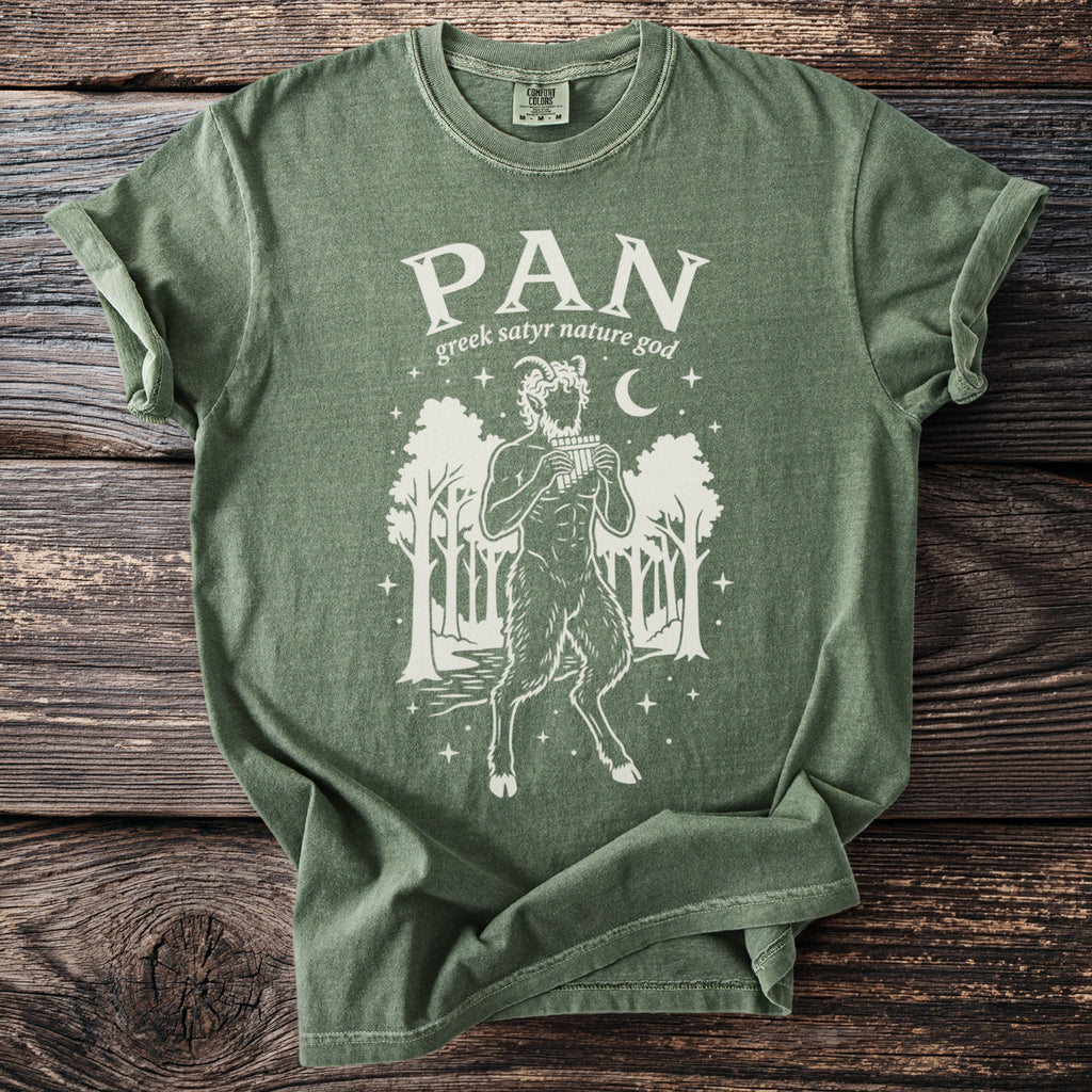 Green t-shirt with a white graphic of the god Pan playing panpipes in a forest.