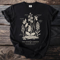 Black t-shirt with line art of bog orchids titled "The Sunken Garden Bog Orchid Plate III".
