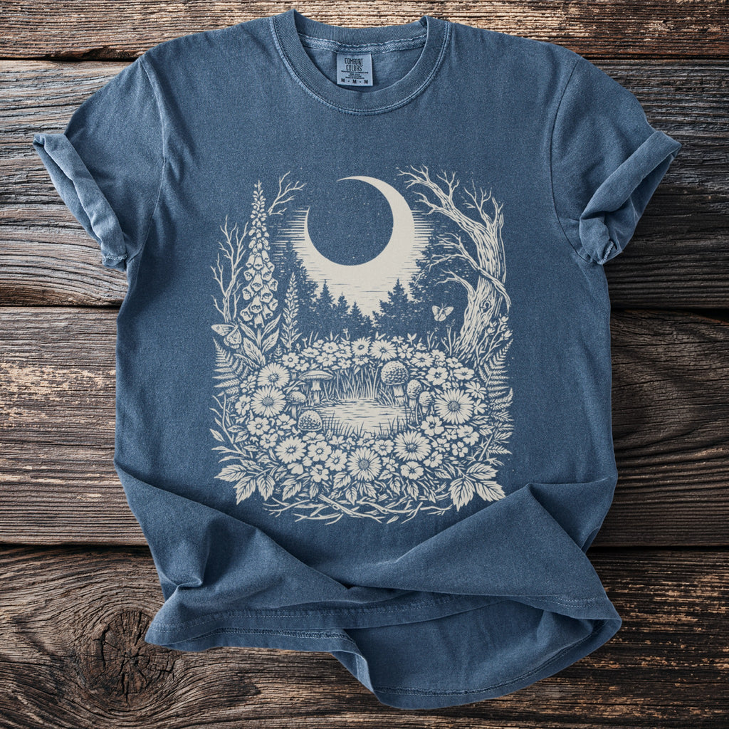 Blue t-shirt with a cream vintage woodland scene featuring a moon and forest.