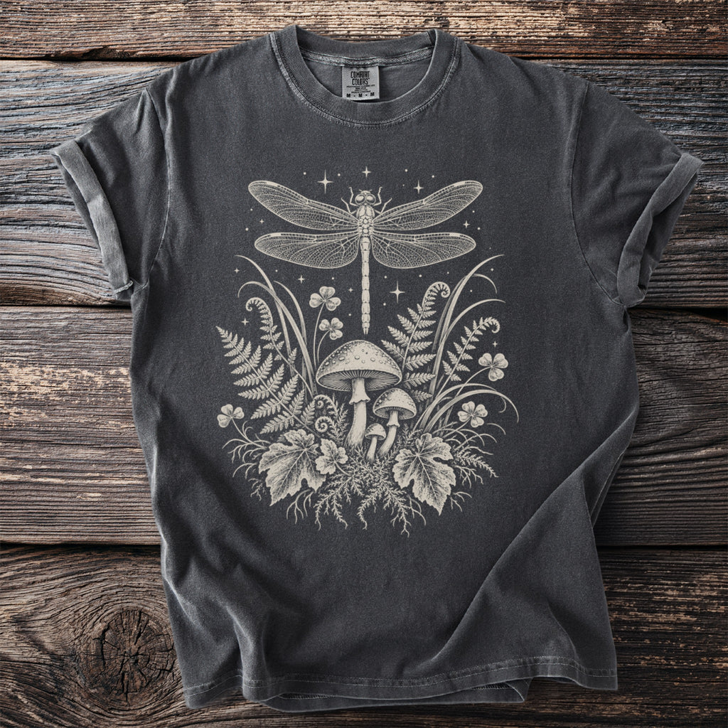 Grey t-shirt with a cream-colored illustration of a dragonfly, mushrooms, ferns, and clover.