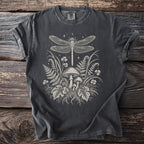 Grey t-shirt with a cream-colored illustration of a dragonfly, mushrooms, ferns, and clover.