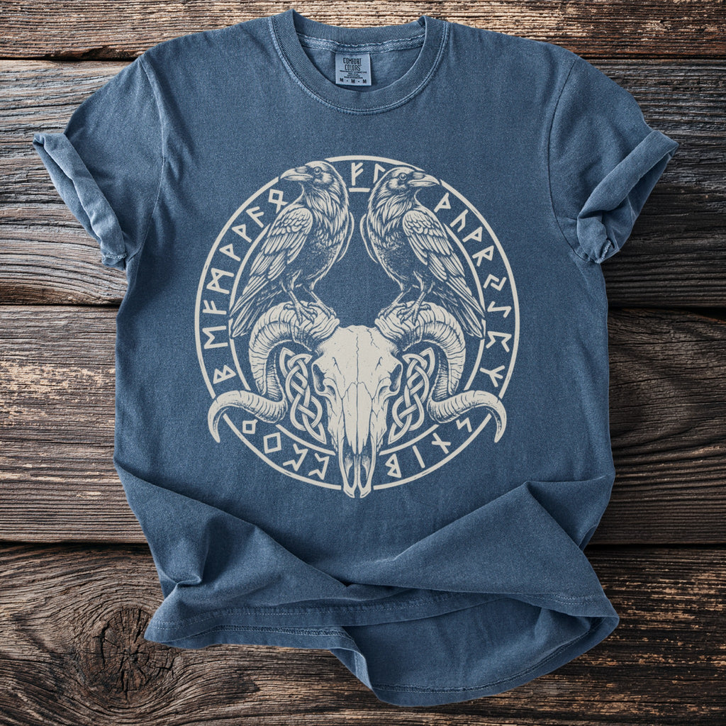Blue t-shirt with a white circular graphic of ravens, ram skull, and runic symbols.