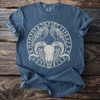 Blue t-shirt with a white circular graphic of ravens, ram skull, and runic symbols.