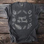 Dark gray t-shirt with "respect the locals" text and botanical illustration.