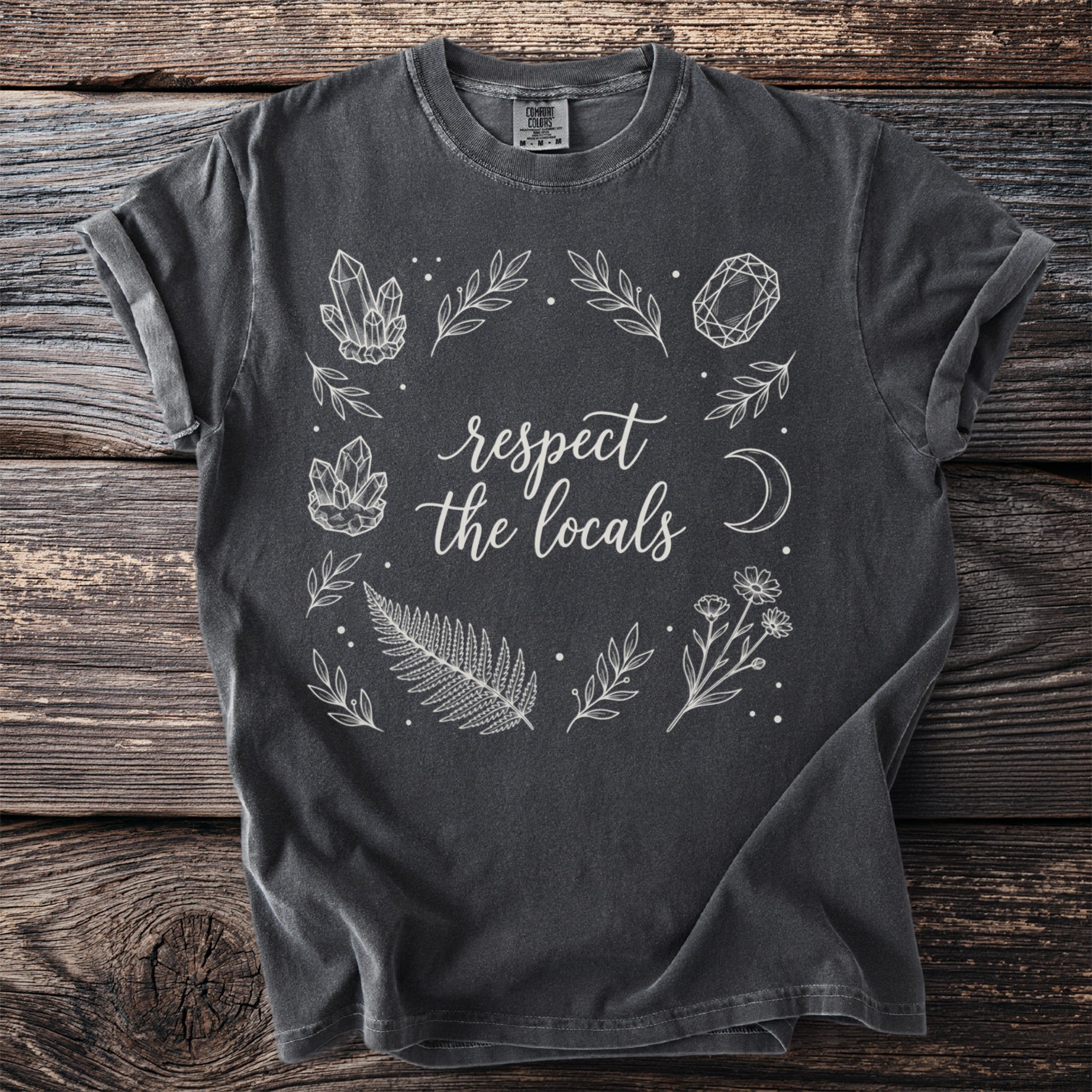 Dark gray t-shirt with "respect the locals" text and botanical illustration.