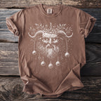 Brown t-shirt with a white print of a horned, bearded figure and ornaments.