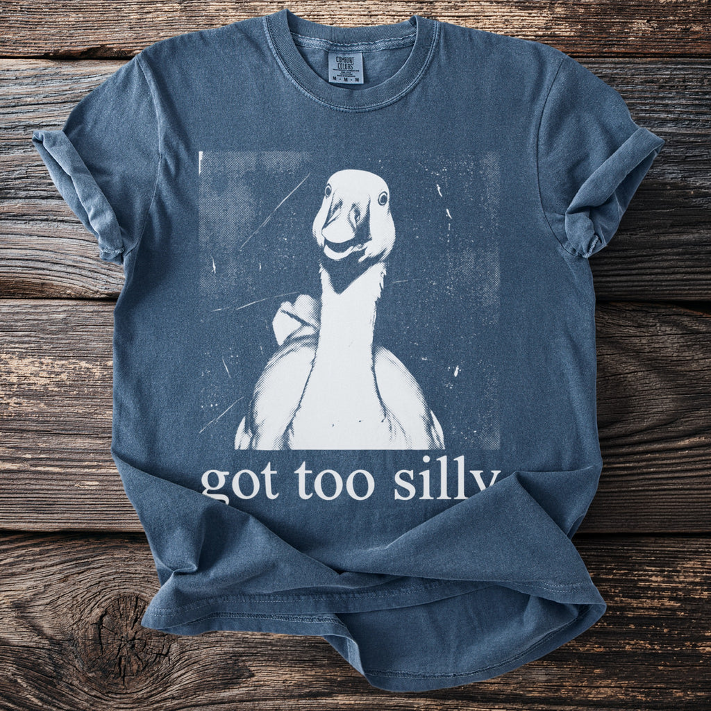 Blue t-shirt with a white graphic of a goose and text "got too silly".