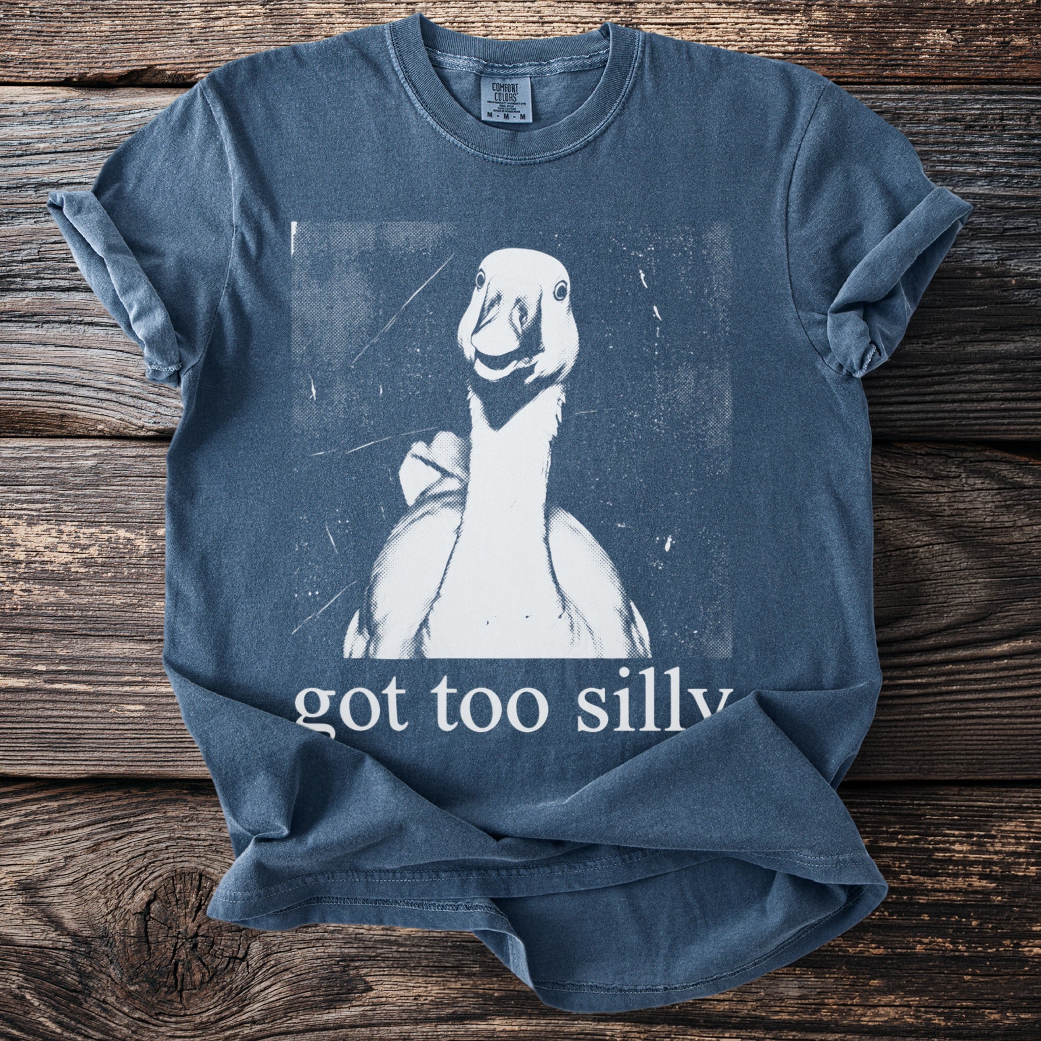 Blue t-shirt with a white graphic of a goose and text "got too silly".