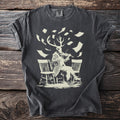 T-shirt with deer-headed figure playing violin among floating papers.