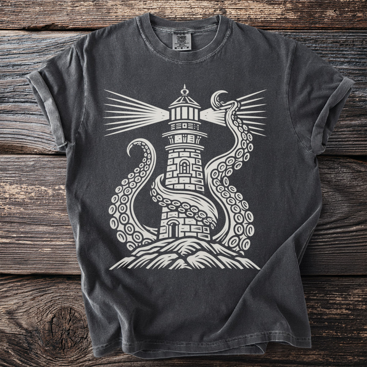 Dark t-shirt with white graphic of a lighthouse being embraced by an octopus.