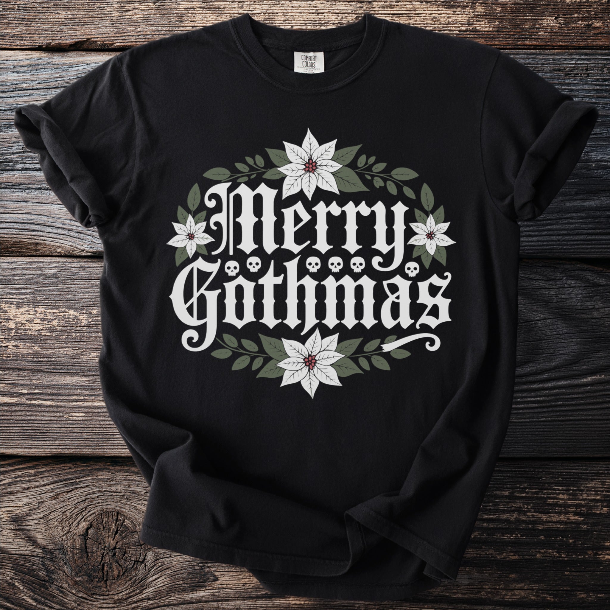 Black t-shirt with "Merry Gothmas" text, skulls, poinsettias, and leaves.
