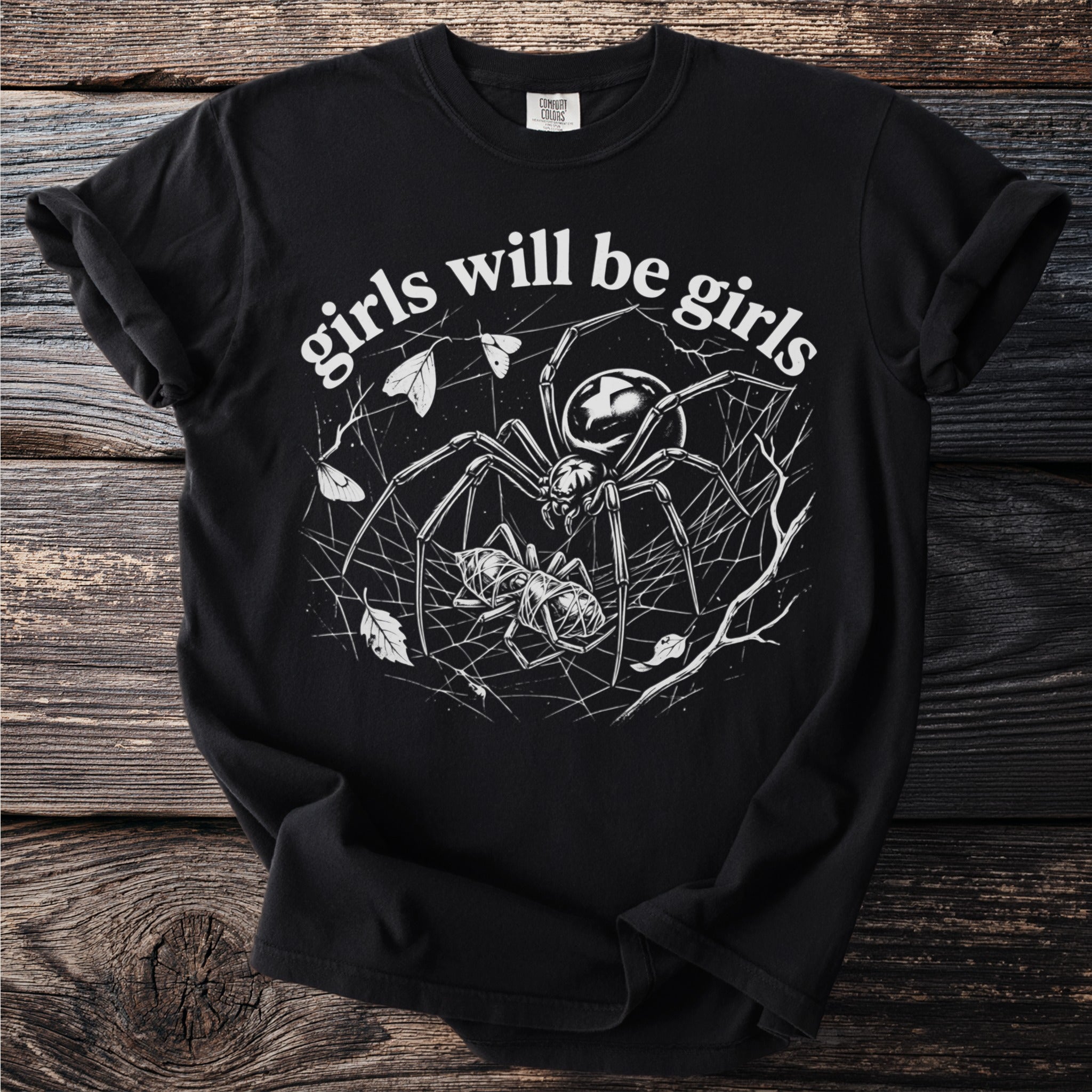 Black Comfort Colors t-shirt with spider and prey graphic and text "girls will be girls".