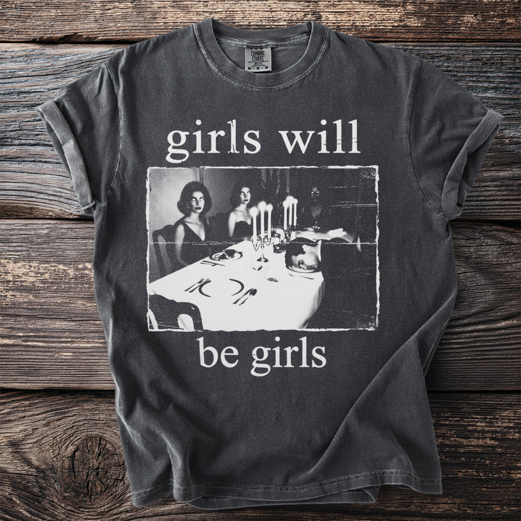 T-shirt with text "girls will be girls" and vintage dinner party image.