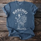 Blue t-shirt with Koschei graphic: skeleton king holding orb, castle, tree, moon, stars.
