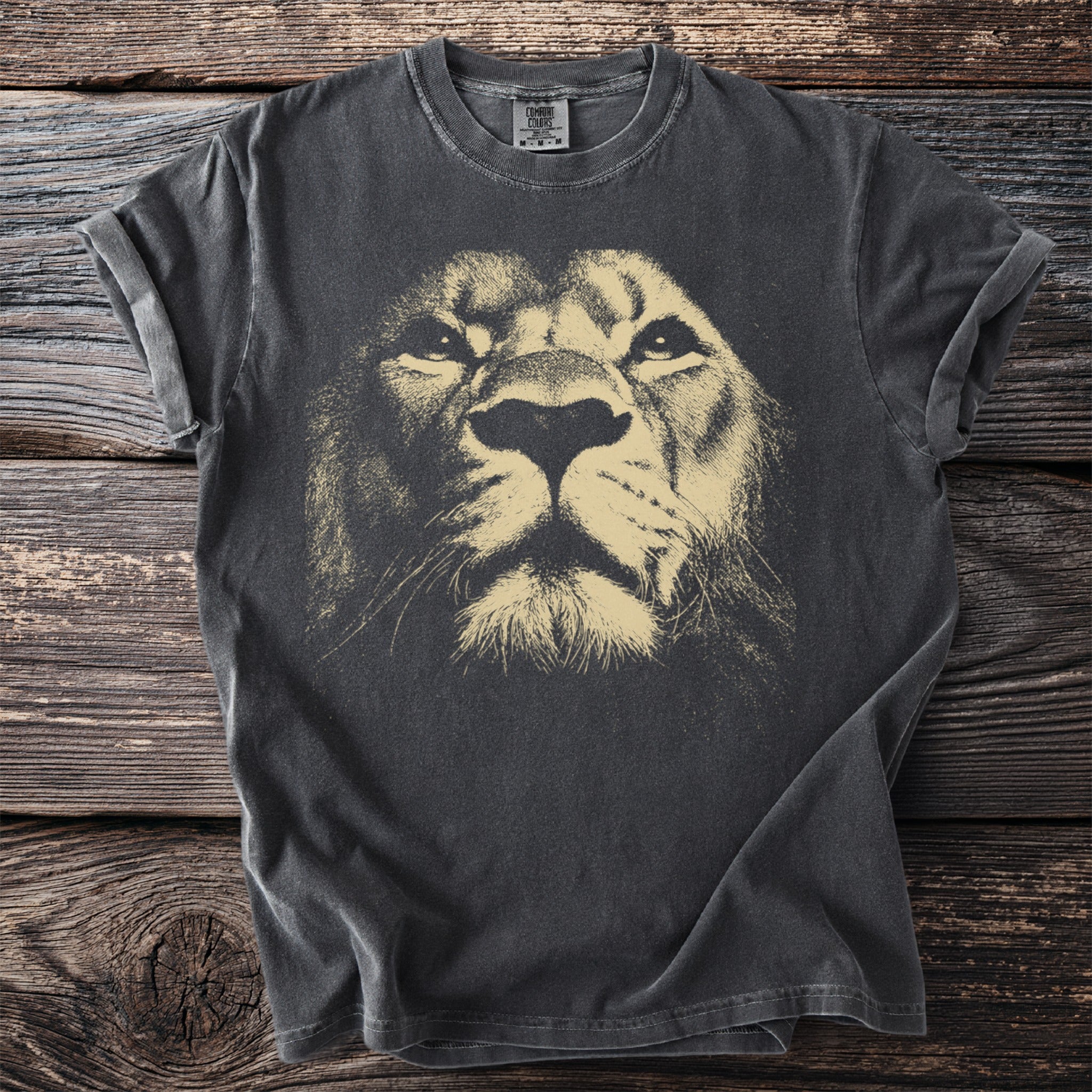 Dark t-shirt with a faded beige lion face graphic on the front.
