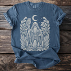Blue t-shirt with a white ink drawing of a wizard, owl, moon, and forest elements.