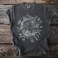 Dark grey t-shirt with a white line drawing of Krampus surrounded by chains and bells.