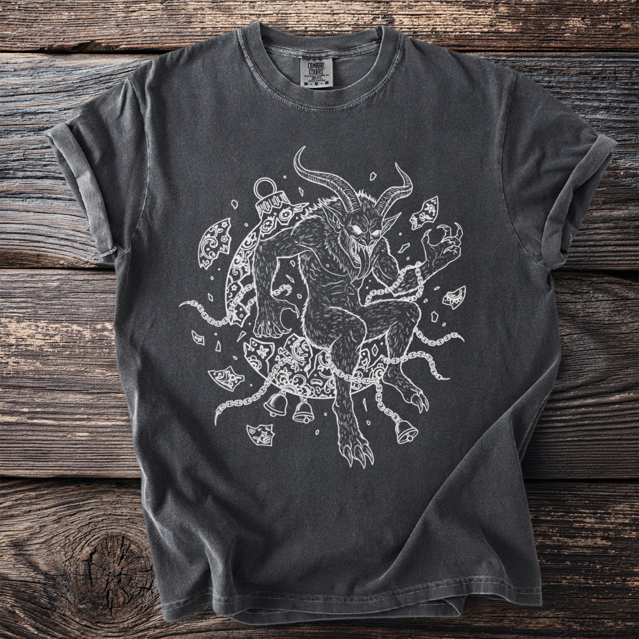 Dark grey t-shirt with a white line drawing of Krampus surrounded by chains and bells.