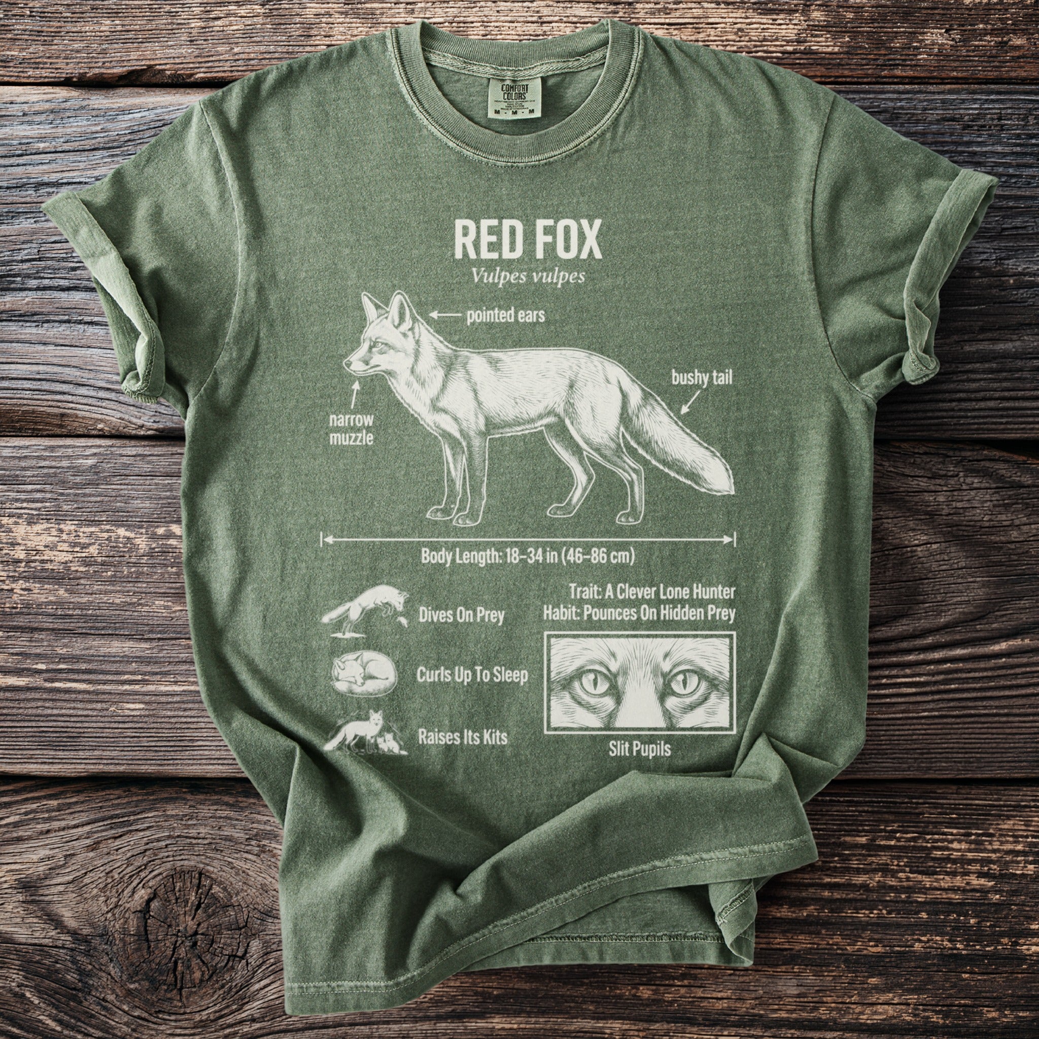 Green t-shirt with white illustration and text about red foxes.