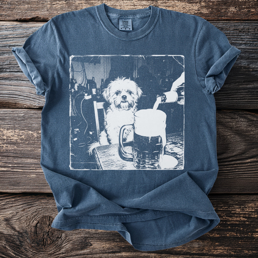 White graphic of a dog sitting at a table, with a beer being poured into a mug.