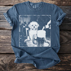 White graphic of a dog sitting at a table, with a beer being poured into a mug.