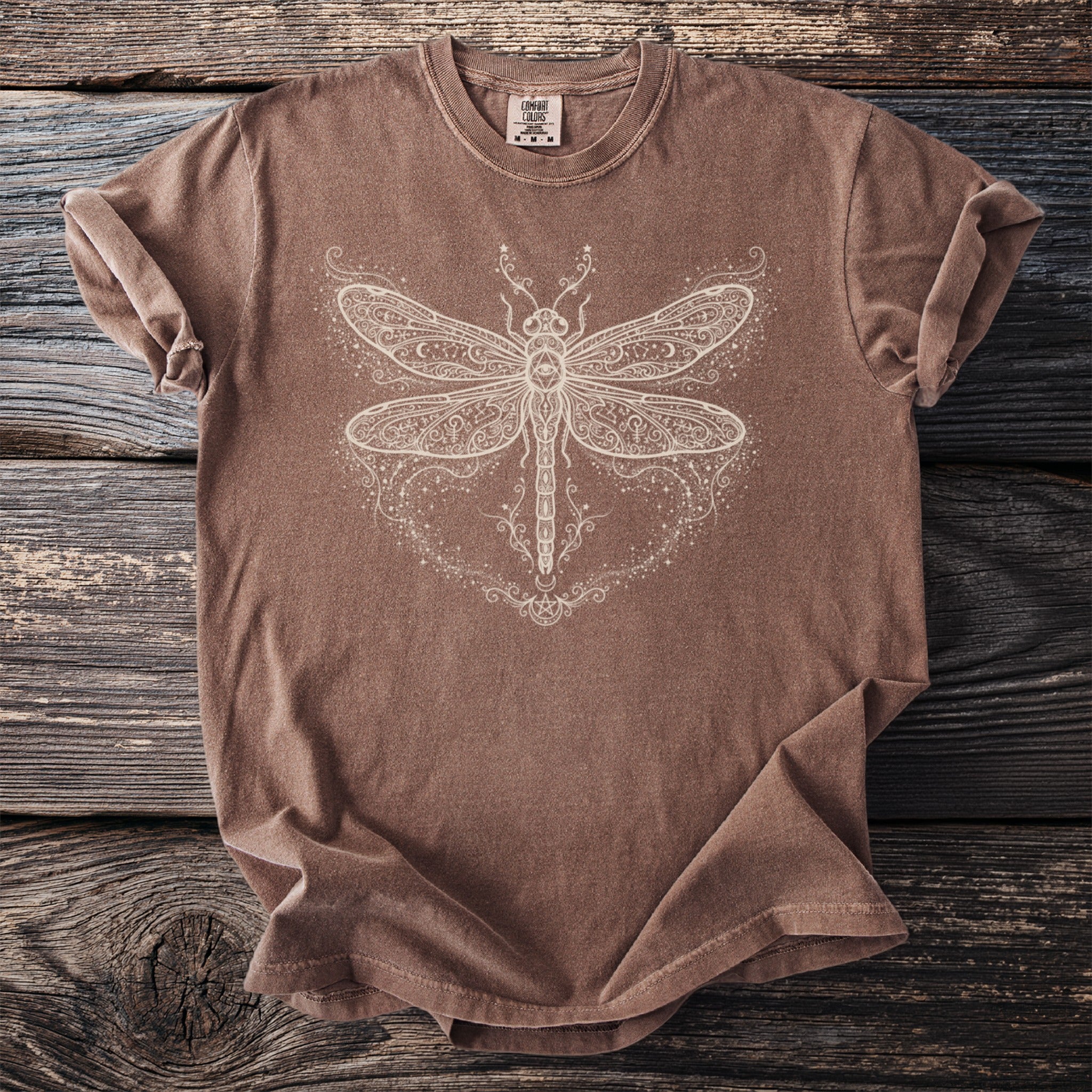Brown t-shirt with a white, ornate dragonfly graphic design.