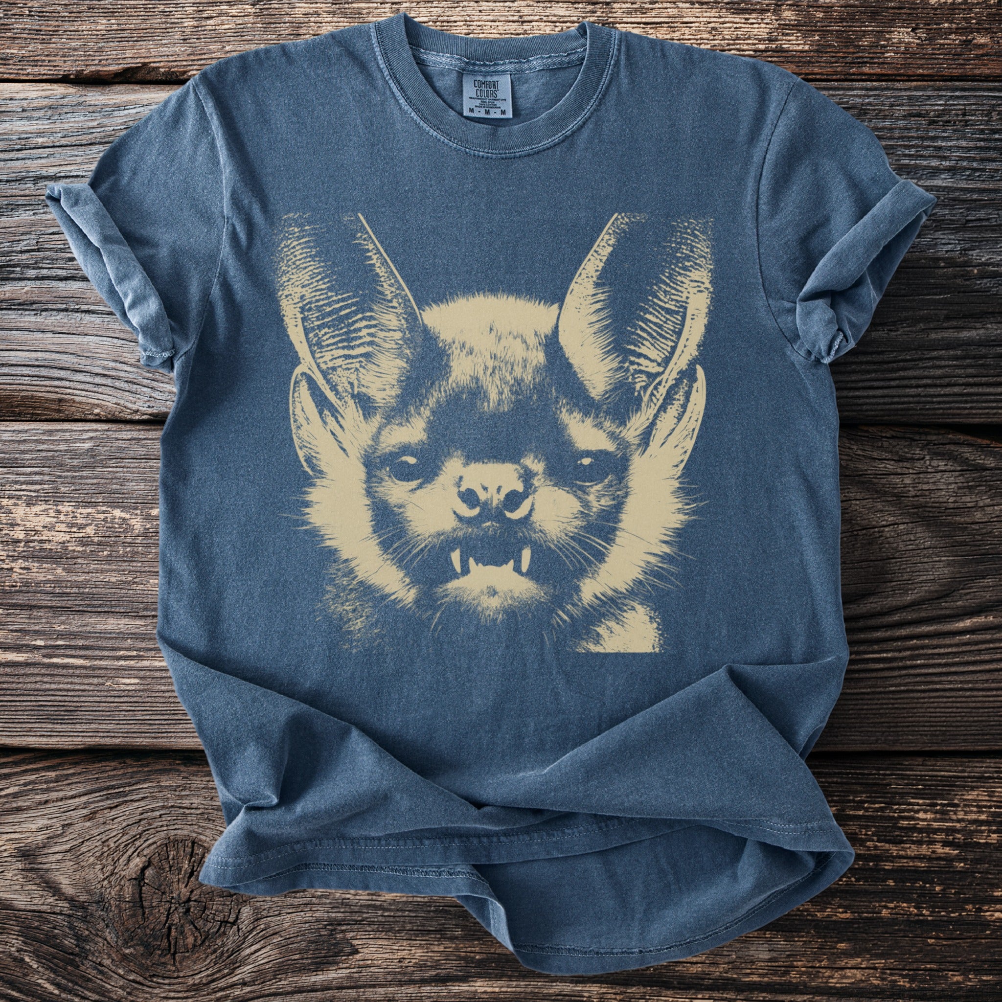 Navy t-shirt with a beige bat face graphic and Comfort Colors label.