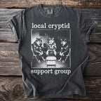 Dark grey t-shirt with "local cryptid support group" and wolf illustration.