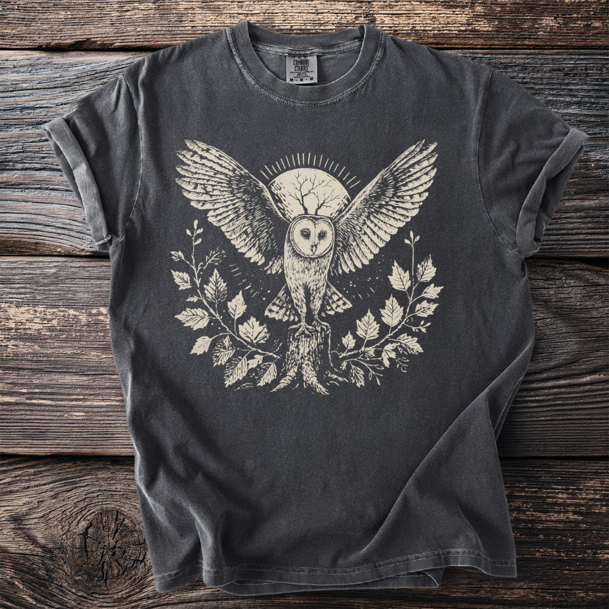 Dark grey t-shirt featuring a cream-colored linocut style print of a barn owl.