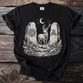 Black t-shirt with a white illustration of a stag between two stone monoliths under a crescent moon.