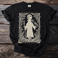 Black t-shirt with a beige graphic of a robed figure with a staff, two ravens, and moon.