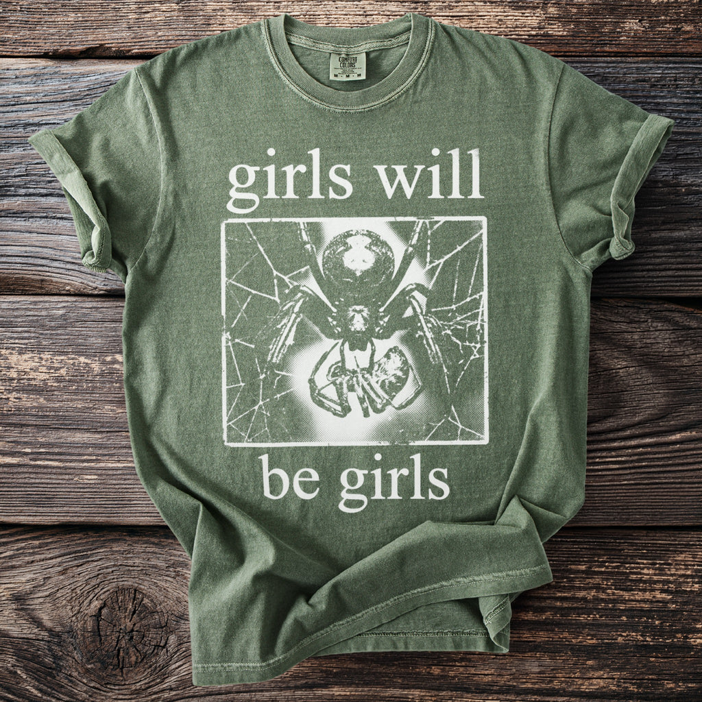 Green t-shirt with "girls will be girls" text and spider graphic.