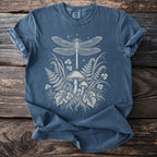 Blue t-shirt with dragonfly, mushrooms, and ferns graphic artwork.