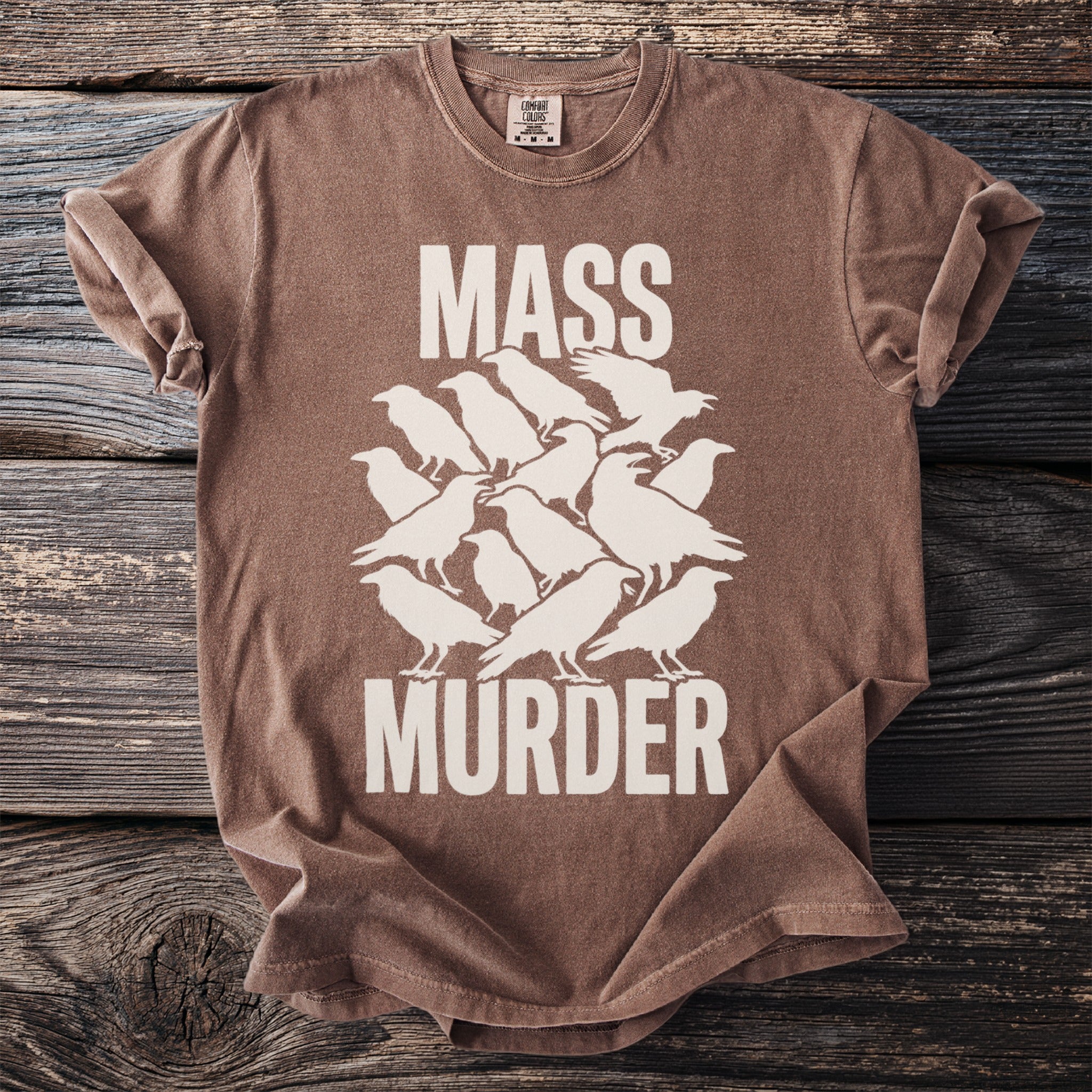 Brown t-shirt with white text and crow graphic: "MASS MURDER"