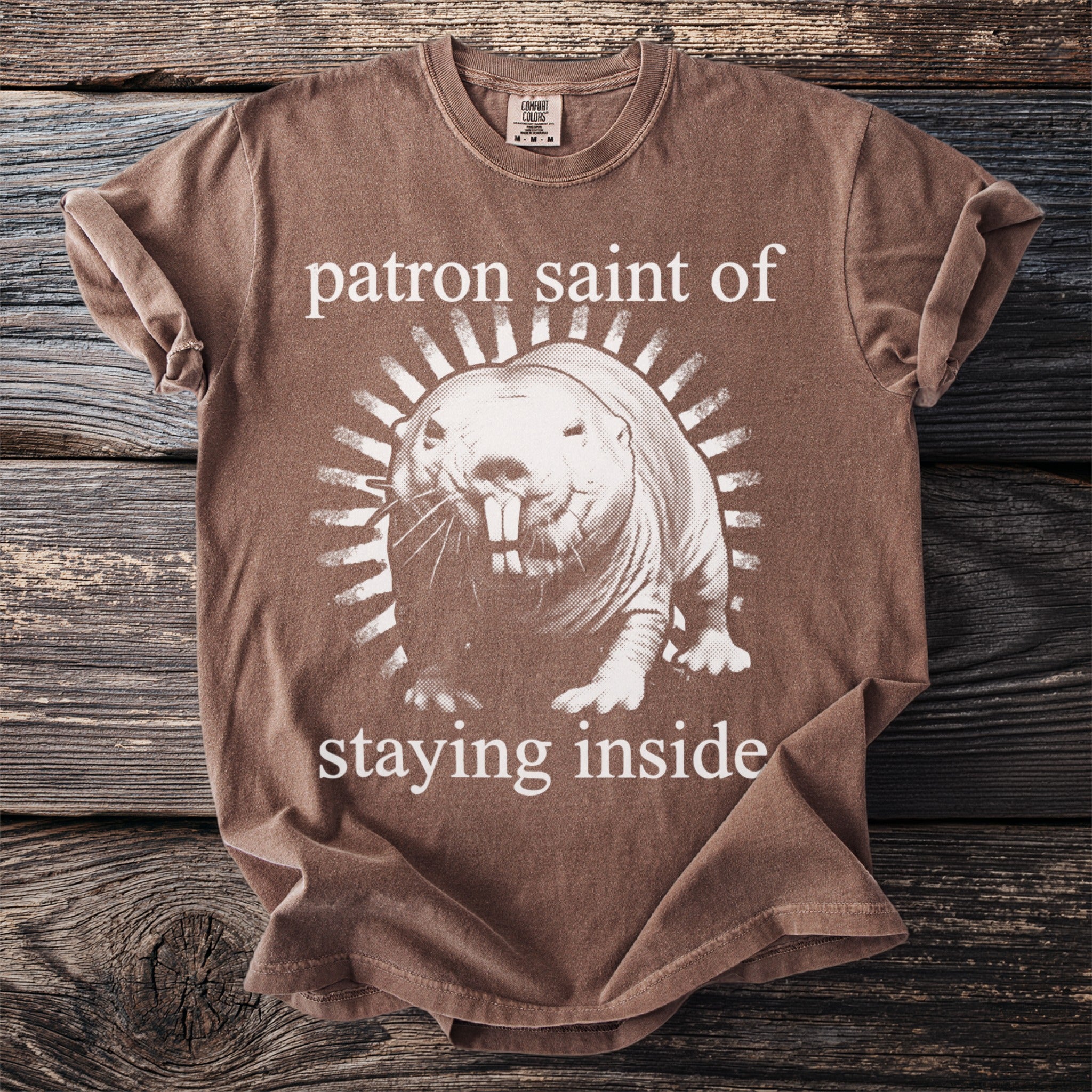 Brown t-shirt with naked mole rat graphic and text "patron saint of staying inside."